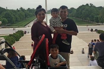 Family smiling in front of Washington Monument