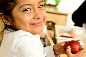 Girl smiling holding apple
