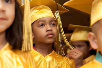 Young boy in graduation cap and gown