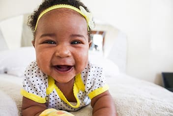 Baby smiling in crib