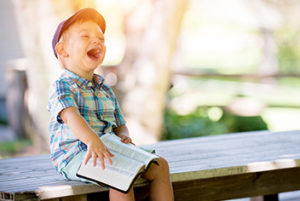 Boy on bench laughing