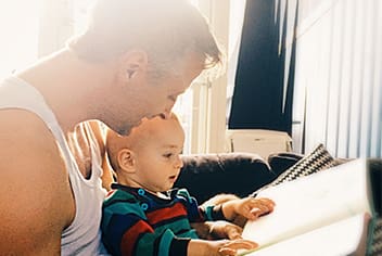 Man reading with baby