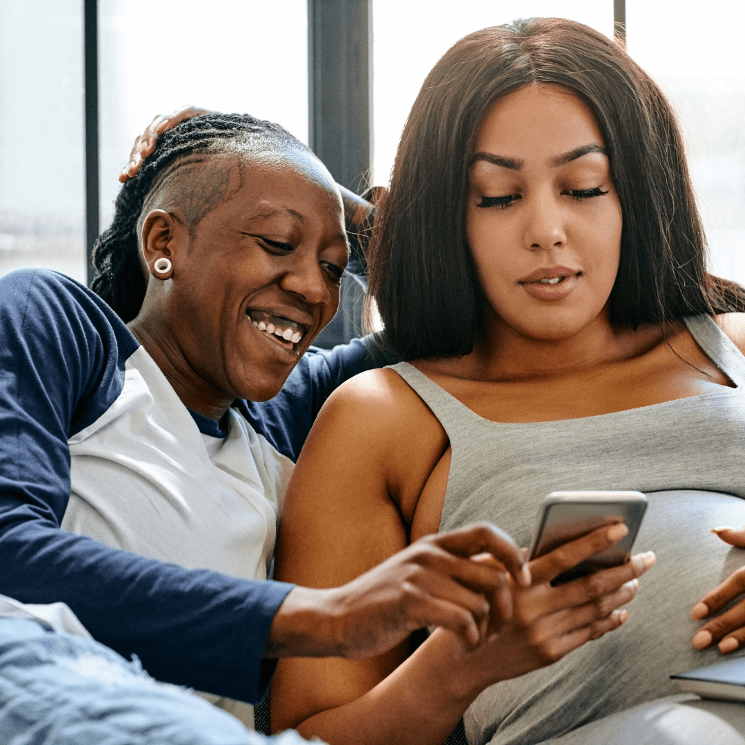 Pregnant couple on couch relaxing