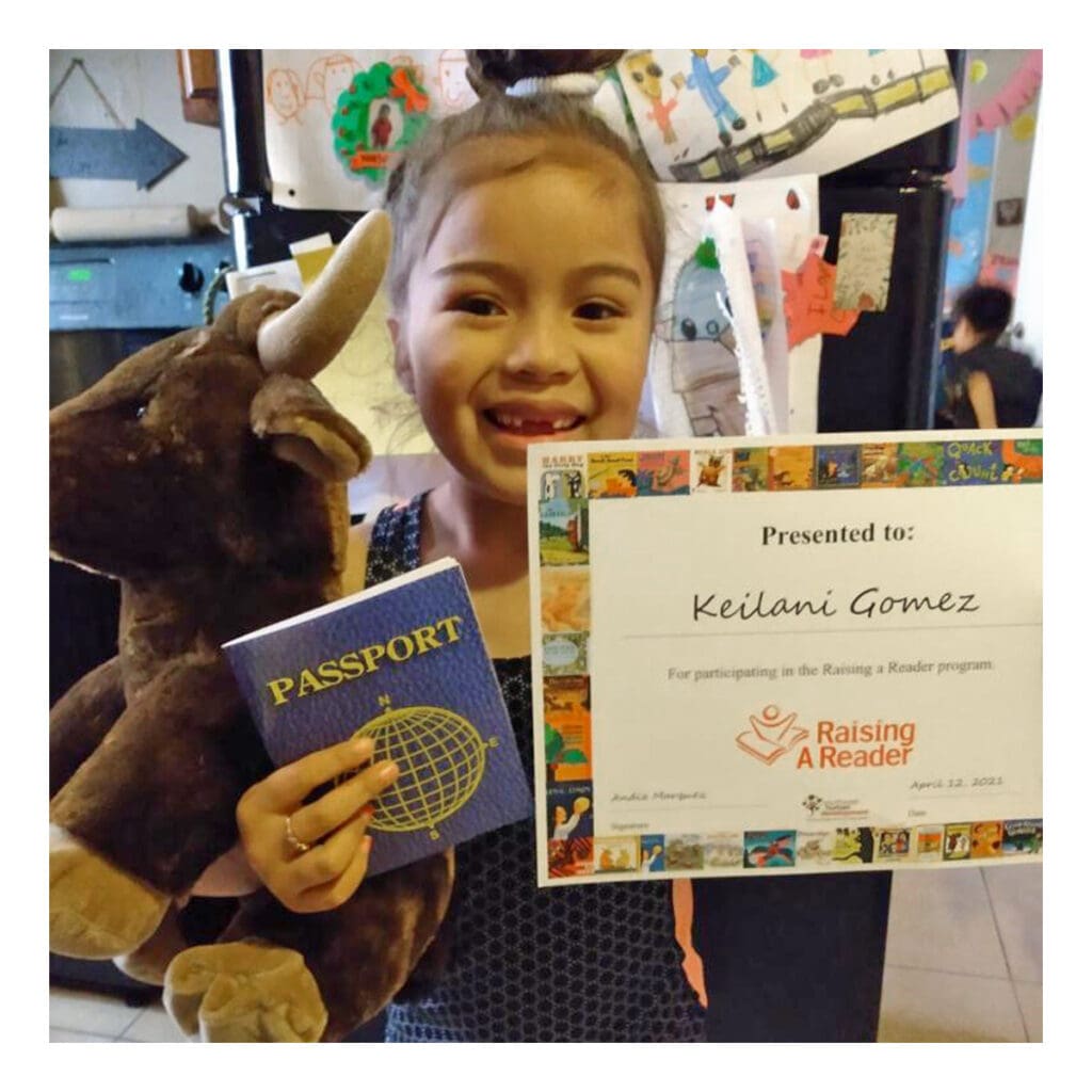 a child proudly showing her certificate